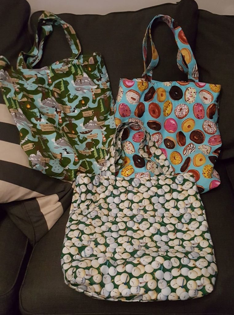 3 tote bags: animals and provinces, golf balls, and donuts