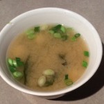 Bowl of miso soup with fresh green onions added after cooking