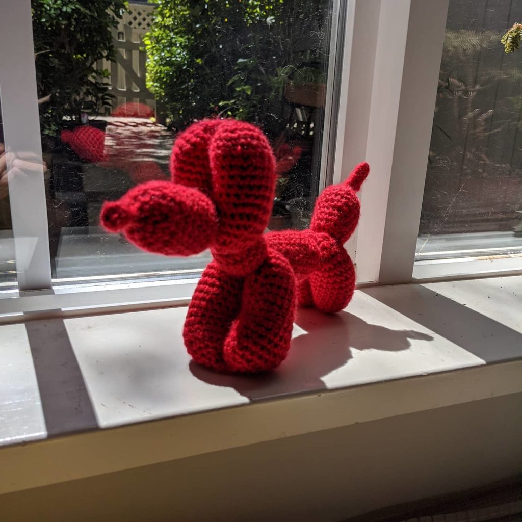 Crocheted red balloon dog