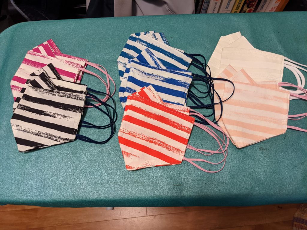 Folded cloth masks on ironing board