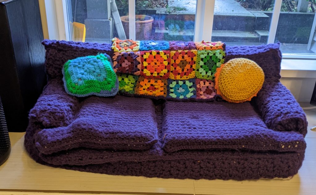Cat couch with 2 cushions and colorful afghan blanket
