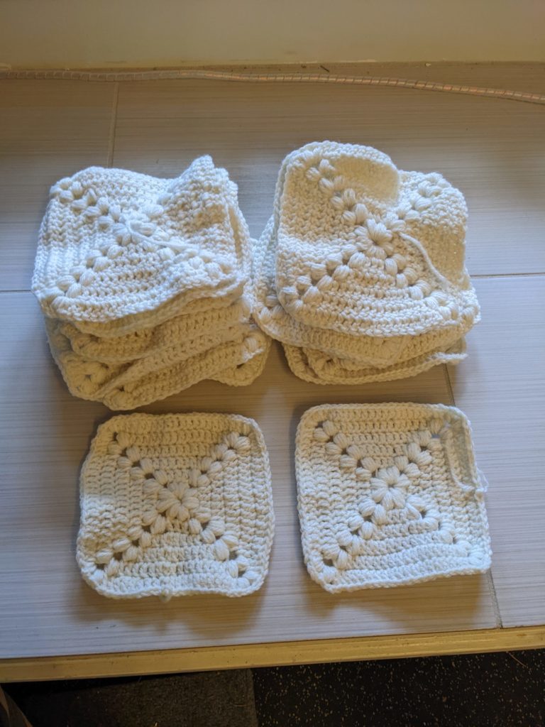 Layout of several Farmhouse squares, crocheted, in 4 piles